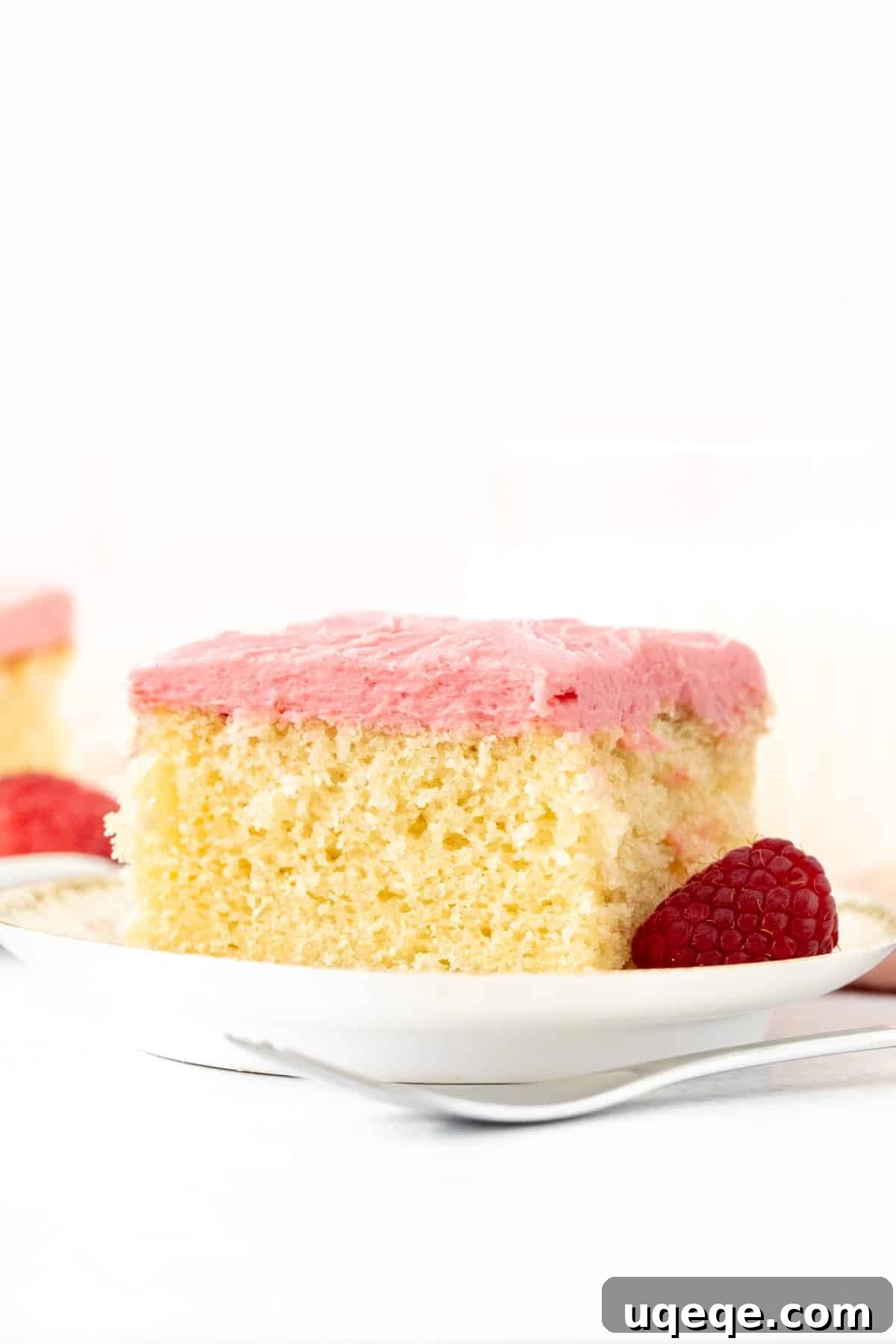 Raspberry Topped Almond Delight 2 Slice of moist almond cake with vibrant raspberry frosting