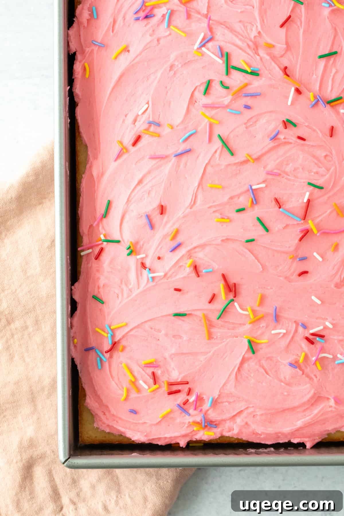 Classic Vanilla Sheet Cake Recipe for Moist, Crowd-Pleasing Dessert 3 9x13 inch pan of vanilla sheet cake with pink frosting