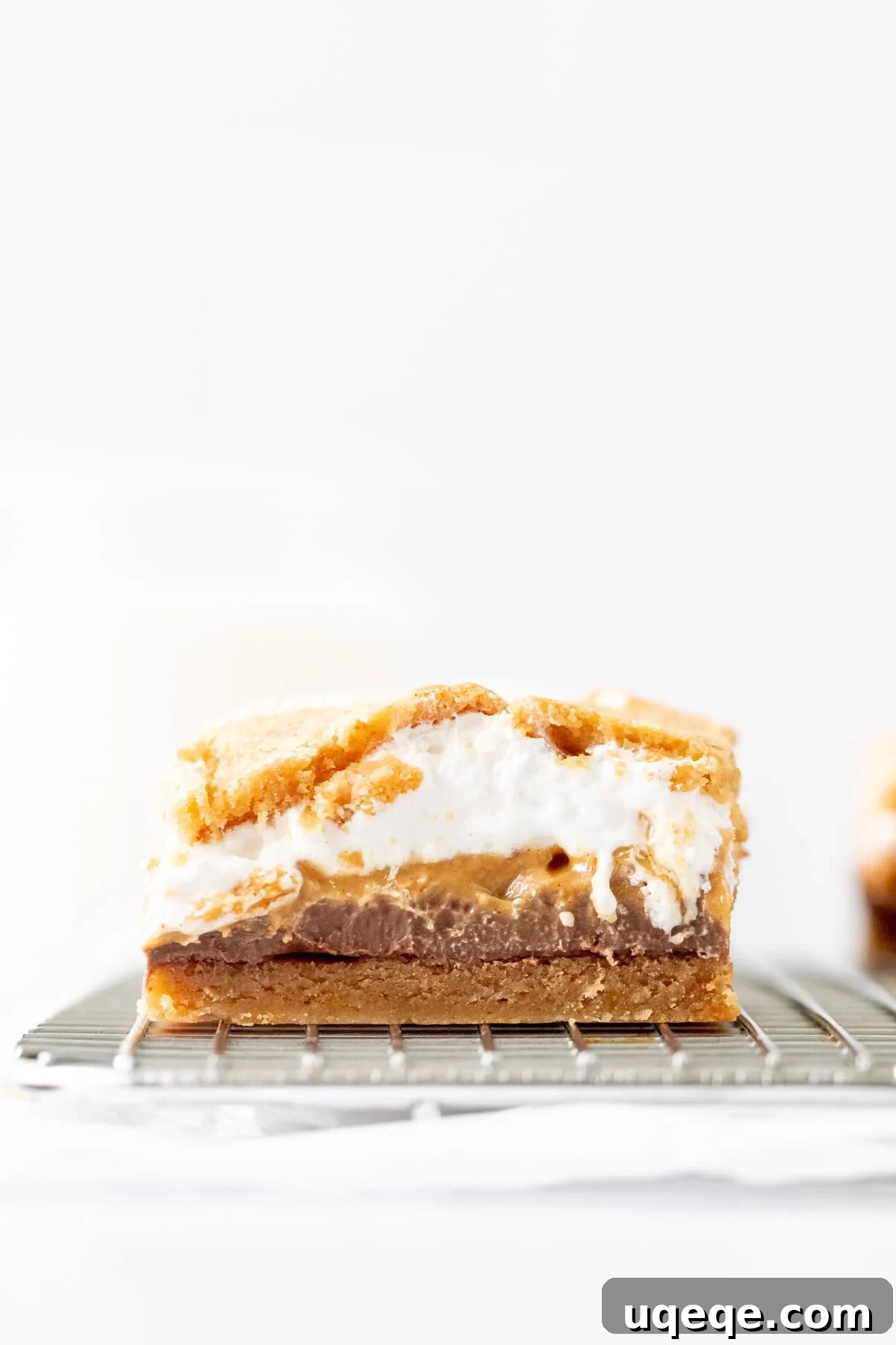 Peanut Butter S'mores Bars Recipe — Gooey Chocolate & Graham Cracker Bars 2 Peanut butter s'mores cookie dough bar on a cooling rack