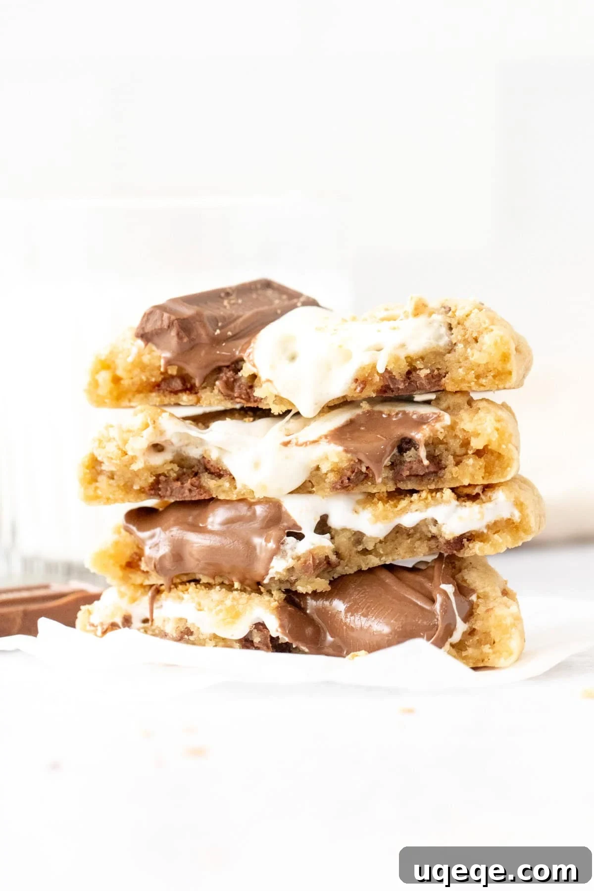 Gooey S'mores Cookies with Chocolate & Toasted Marshmallow 3 Stack of gooey s'mores cookies with marshmallow and melted milk chocolate, broken in half and stacked