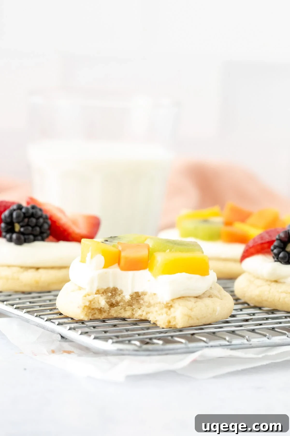Mini Fruit Pizza Bites with Cream Cheese Frosting 6 Individual fruit pizza with a bite taken out