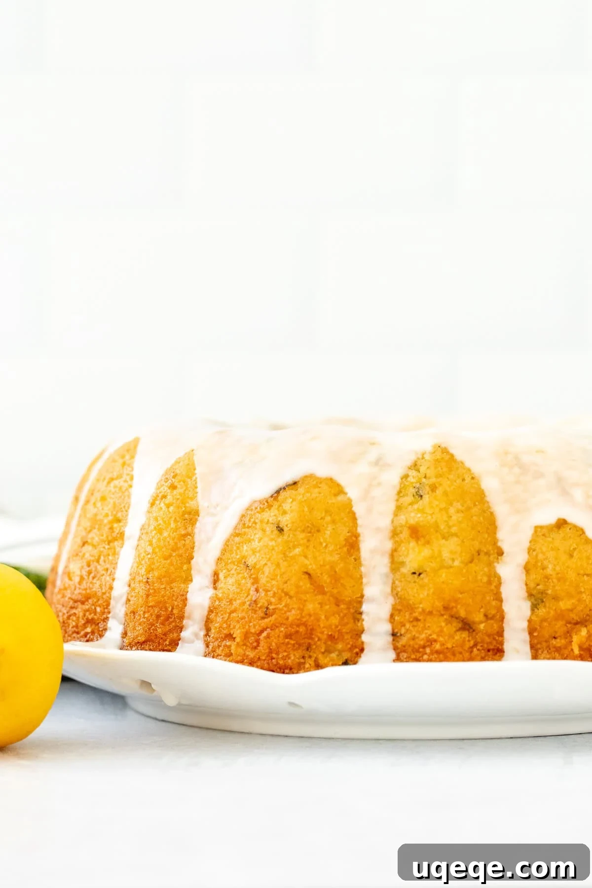Moist Lemon Zucchini Cake with Cream Cheese Glaze 3 lemon zucchini bundt cake topped with a drizzle of lemon glaze.