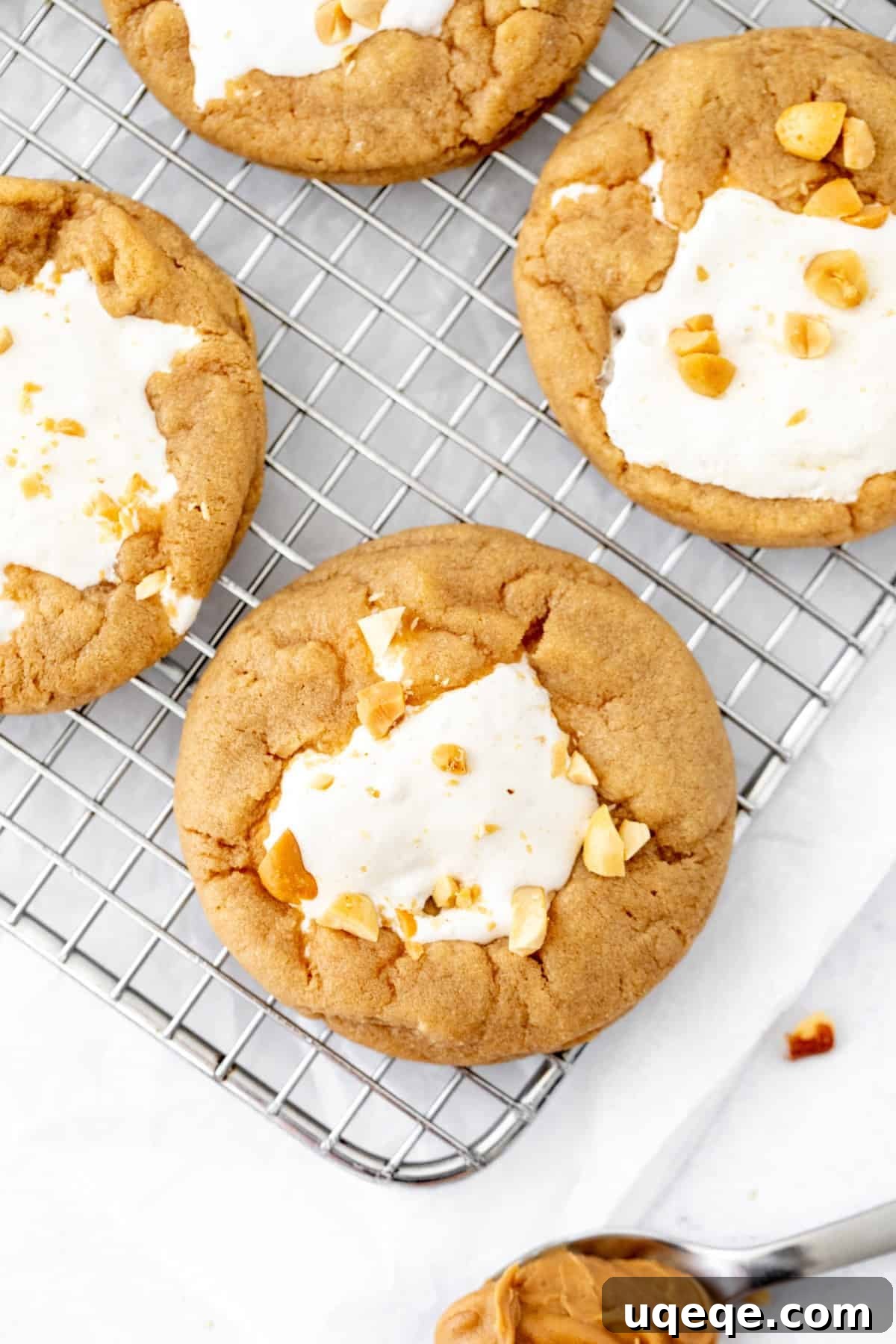 Fluffernutter Cookies: Peanut Butter & Marshmallow Cookies 5 fluffernutter cookies with marshmallow fluff in the middle on a cooling rack