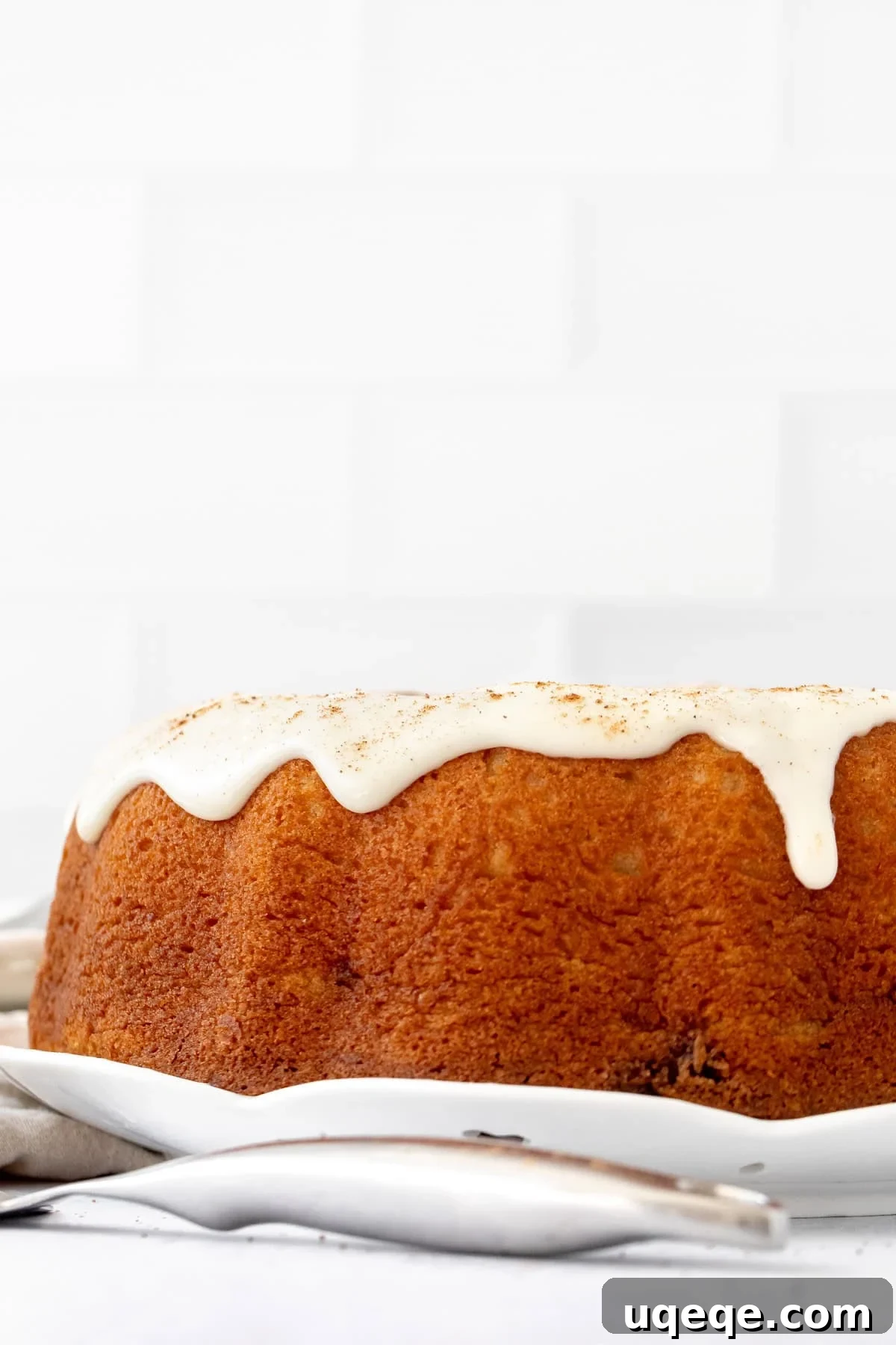Moist Cinnamon Swirl Bundt Cake Recipe 3 cinnamon roll bundt cake topped with cream cheese icing and a sprinkle of cinnamon