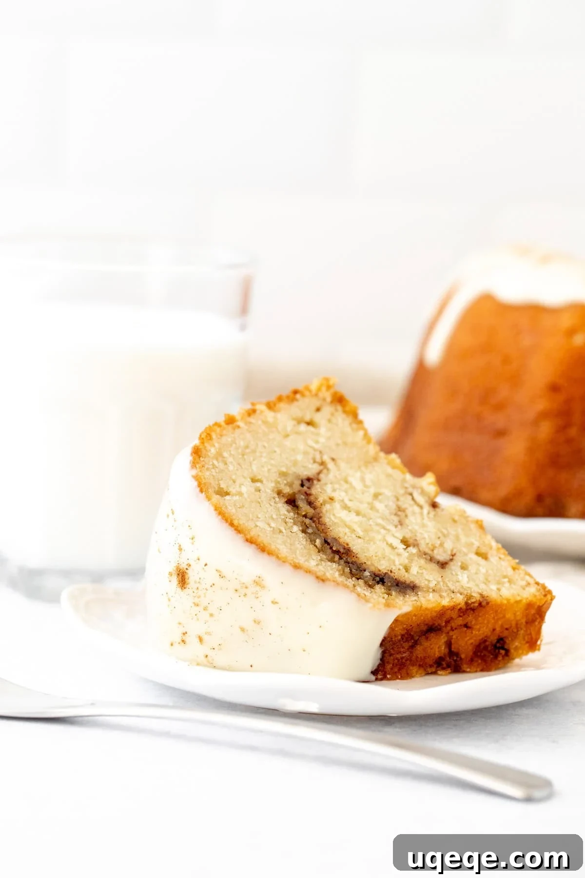 Moist Cinnamon Swirl Bundt Cake Recipe 5 Slice of cinnamon bundt cake with cream cheese icing on top