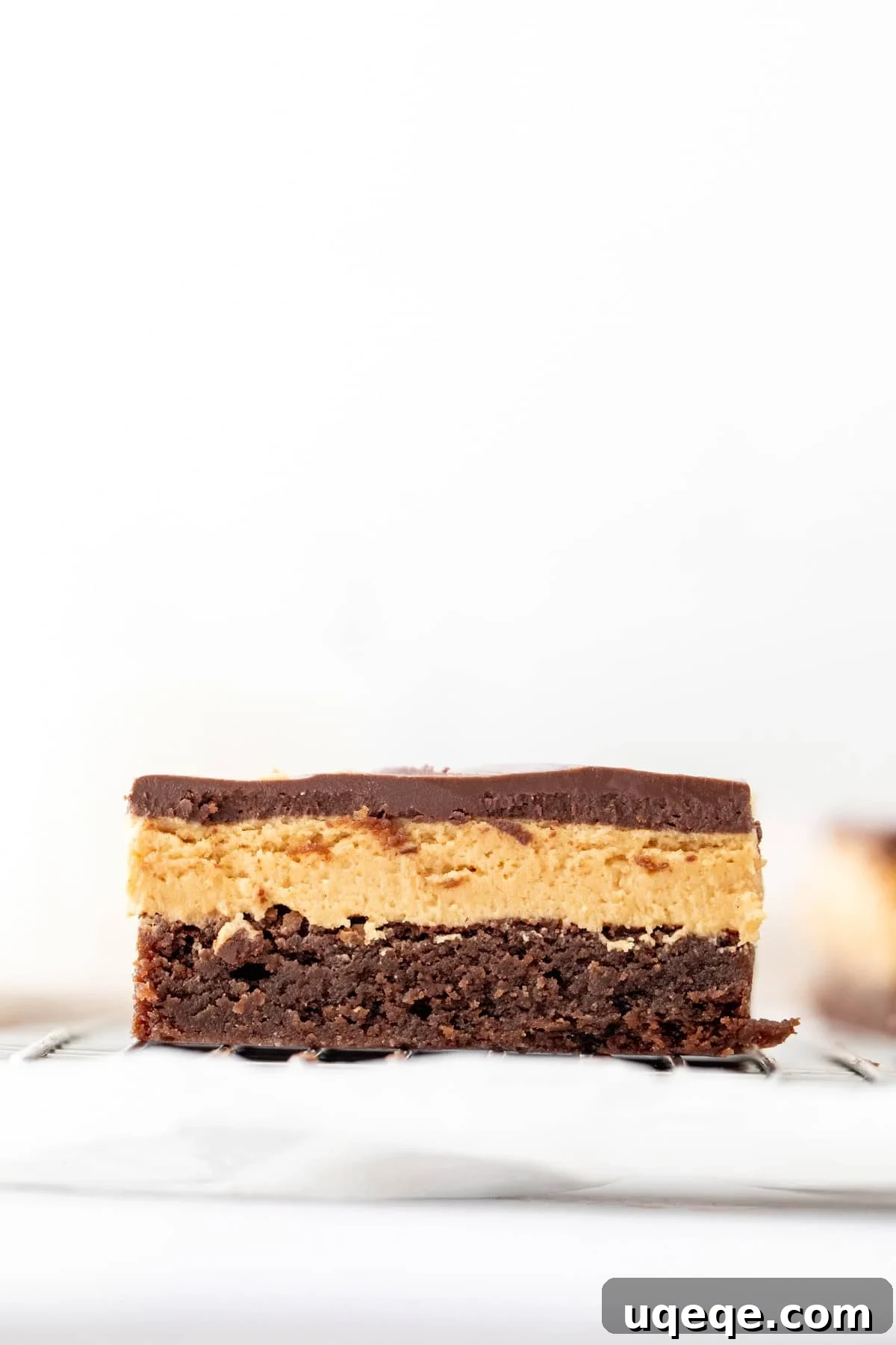 Chocolate Peanut Butter Buckeye Brownies 3 triple layer brownie with peanut butter fudge in the middle and chocolate on top